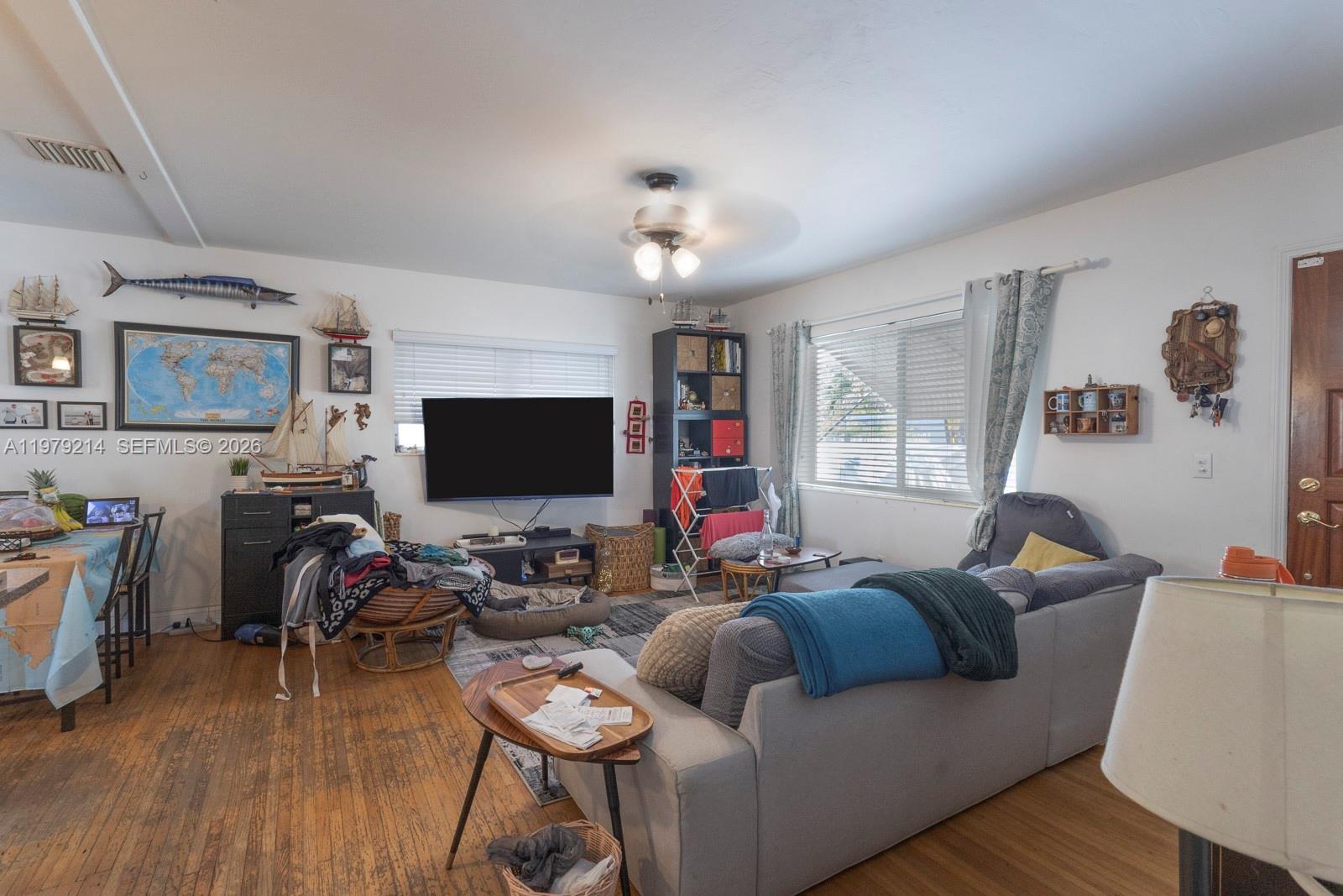 2710 Southwest 28th Court Miami, FL 33133 - Photo 2 of 19 a living room with furniture and a flat screen tv