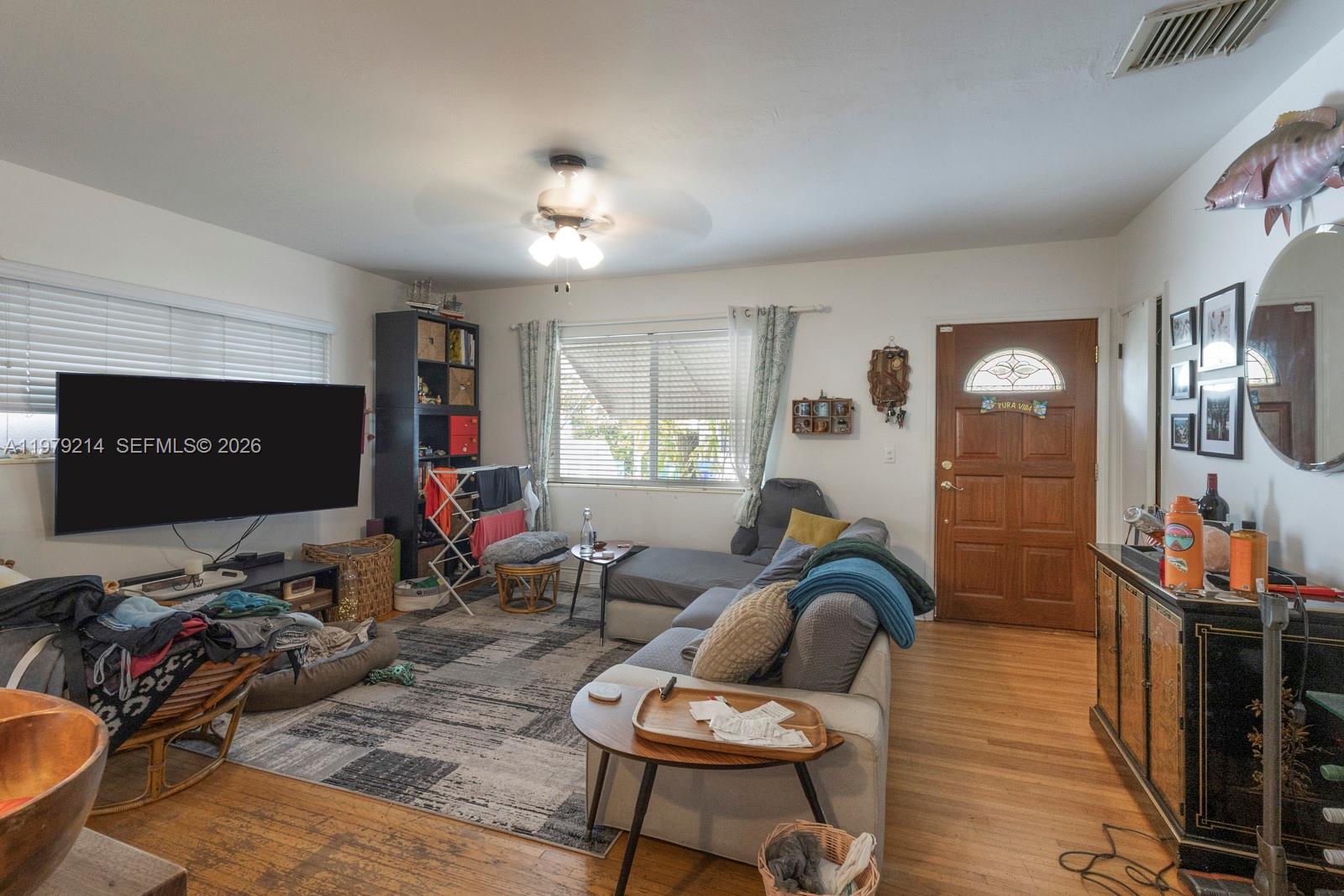 2710 Southwest 28th Court Miami, FL 33133 - Photo 6 of 19 a living room with furniture a window and flat screen tv