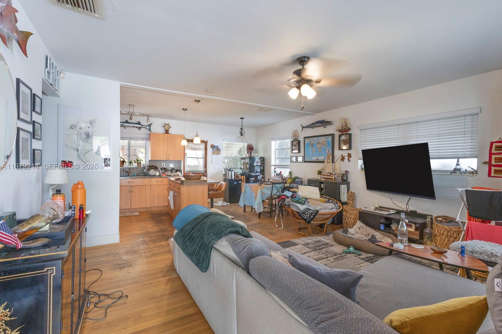 2710 Southwest 28th Court Miami, FL 33133 - Photo 7 of 19 a living room with furniture and a flat screen tv