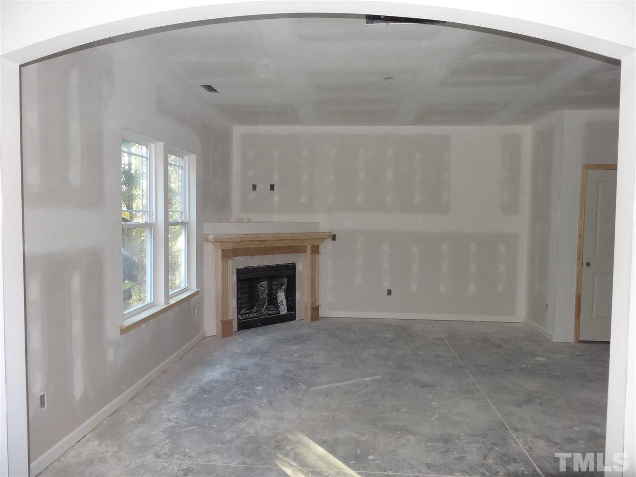 6212 Quitman Trail Raleigh, NC 27610 - Photo 2 of 20 a view of an empty room with a fireplace