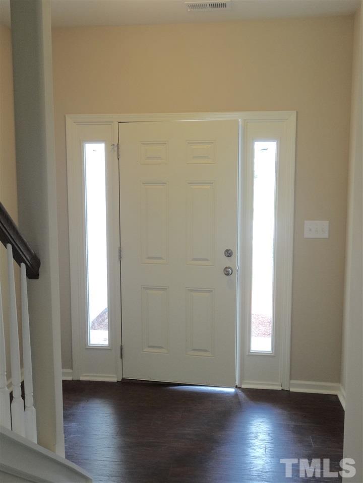 6212 Quitman Trail Raleigh, NC 27610 - Photo 11 of 20 an empty room with wooden floor and windows