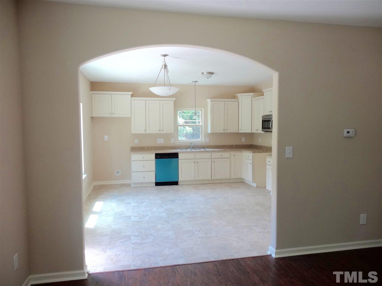 6212 Quitman Trail Raleigh, NC 27610 - Photo 13 of 20 an open kitchen with cabinets and wooden floor