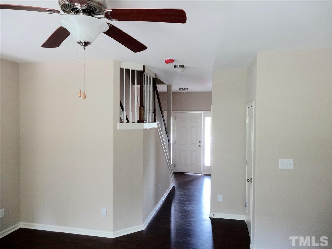 6212 Quitman Trail Raleigh, NC 27610 - Photo 14 of 20 a view of a hallway with wooden floor and staircase
