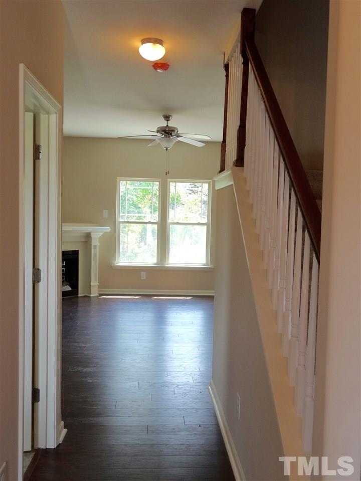 6212 Quitman Trail Raleigh, NC 27610 - Photo 9 of 20 a view of empty room with wooden floor and fan