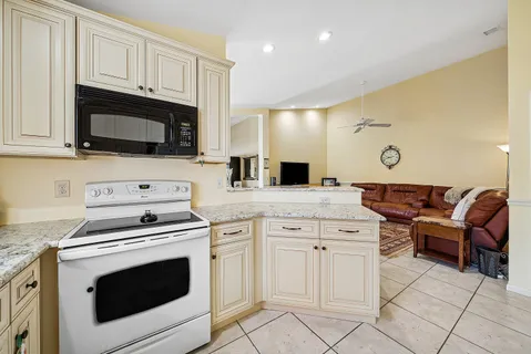 a kitchen with cabinets and steel appliances