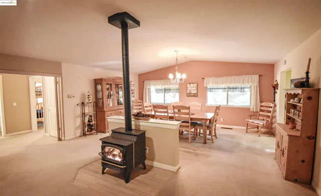 a living room with furniture a flat screen tv and a large window