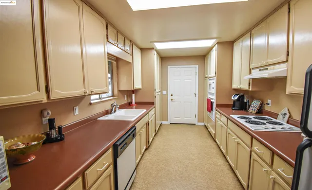 a kitchen with stainless steel appliances a sink stove and cabinets