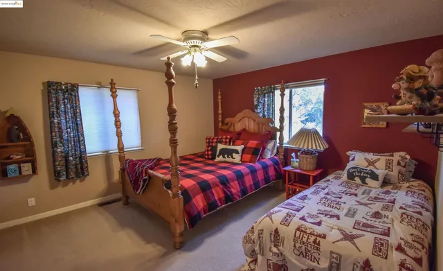 a bedroom with two beds and a chandelier