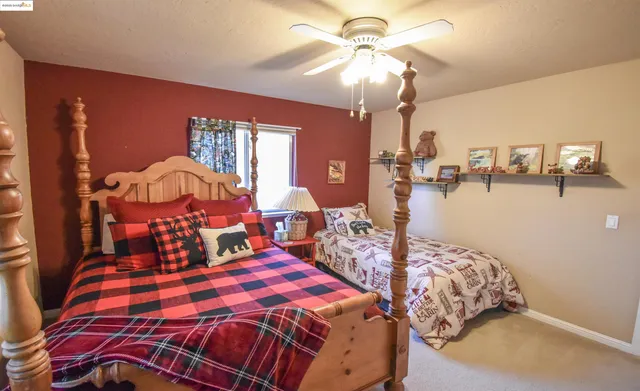 a bedroom with a bed and chandelier