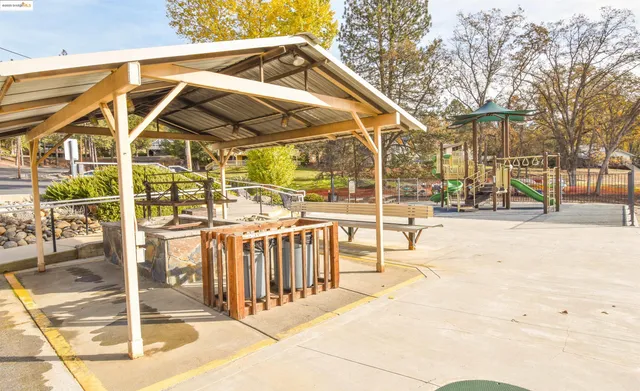 a view of a yard with wooden fence