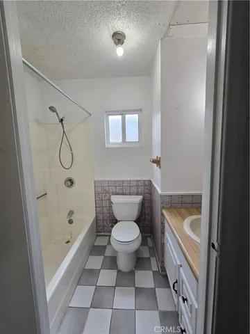 a bathroom with a bathtub and a toilet