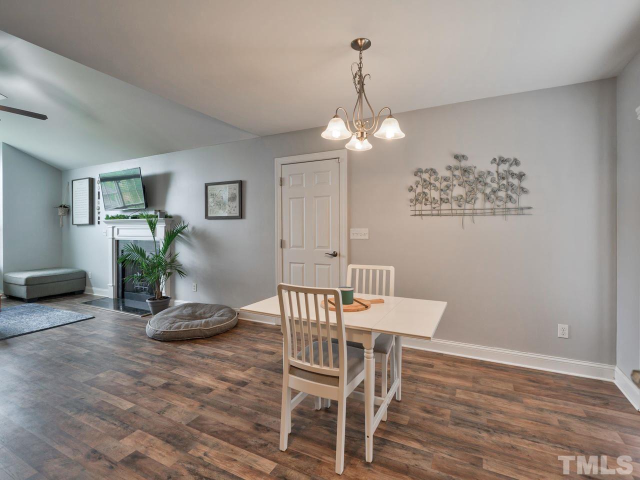 206 Orkney Road Stem, NC 27581 - Photo 8 of 30 a view of a dining room with furniture wooden floor and chandelier