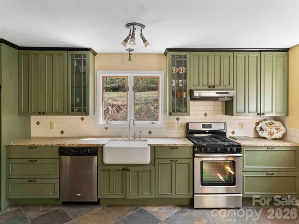 a kitchen that has a sink and a stove