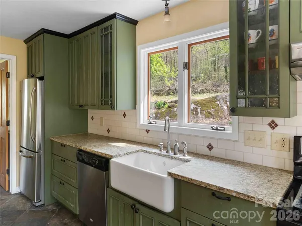 a kitchen with a sink and a refrigerator