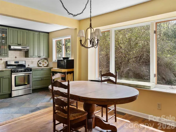 a view of a dining room with furniture window and outside view