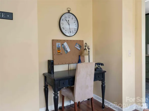 a view of a dining area with furniture and wall clock
