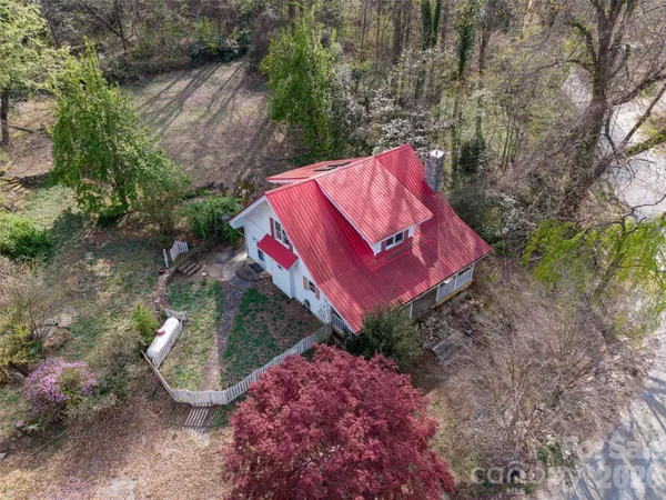 a view of a wooden fence with a house in the background