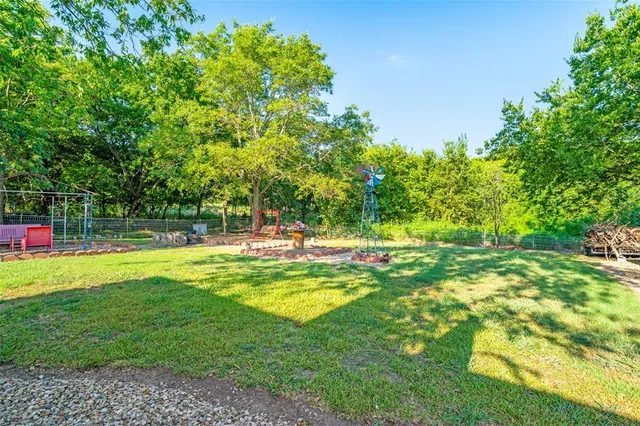 a view of a house with pool and a big yard