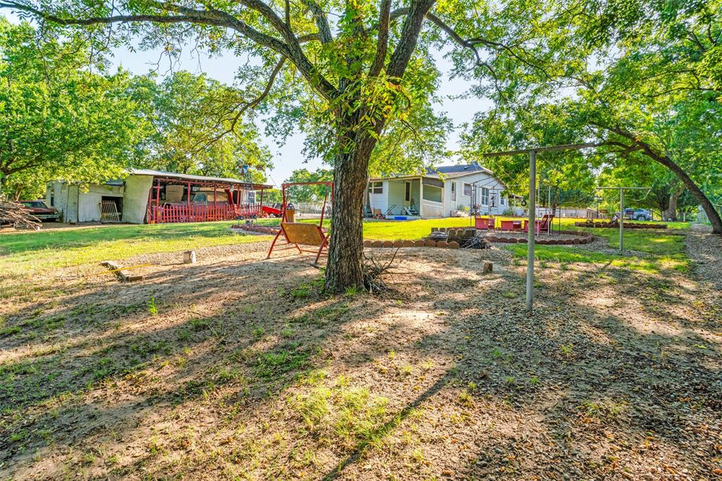 602 North Denison Street Bells, TX 75414 - Photo 16 of 16 a view of a house with pool and a big yard