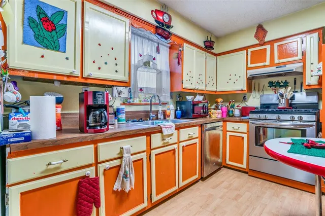 a kitchen with stainless steel appliances granite countertop a sink and cabinets