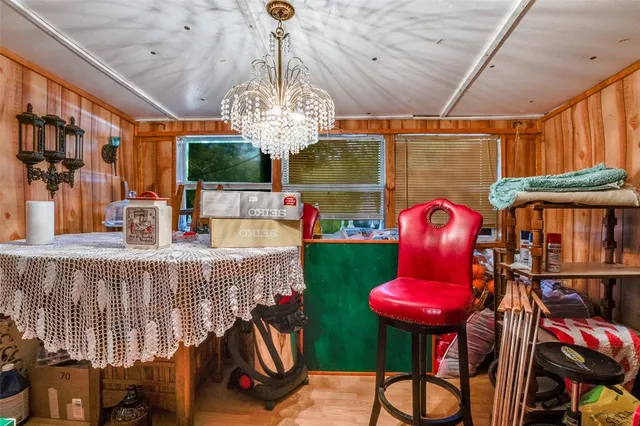 a view of a dining room with furniture chandelier and wooden floor