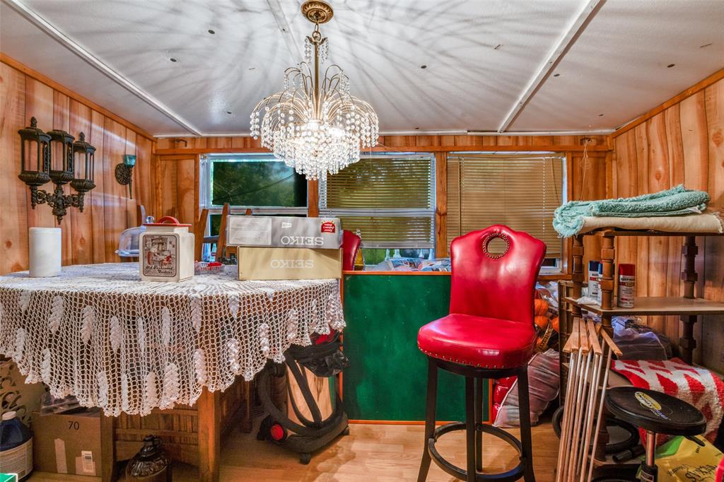602 North Denison Street Bells, TX 75414 - Photo 6 of 16 a view of a dining room with furniture chandelier and wooden floor