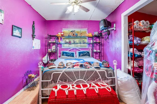 a bedroom with a bed and a lamp