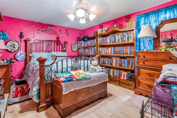 a bedroom with furniture and a book shelf
