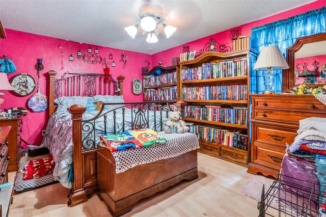 a bedroom with furniture and a book shelf