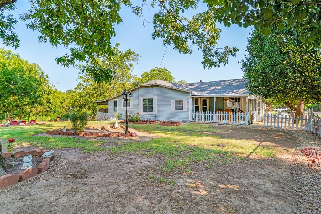 602 North Denison Street Bells, TX 75414 - Photo 10 of 16 a view of a house with a yard