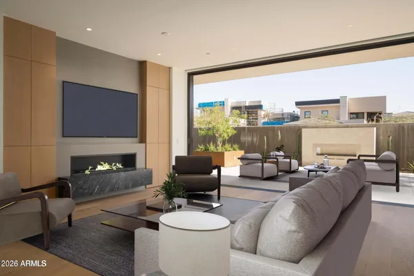 a living room with furniture a fireplace and a large window
