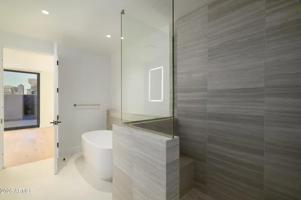 a bedroom with bed and flat screen tv