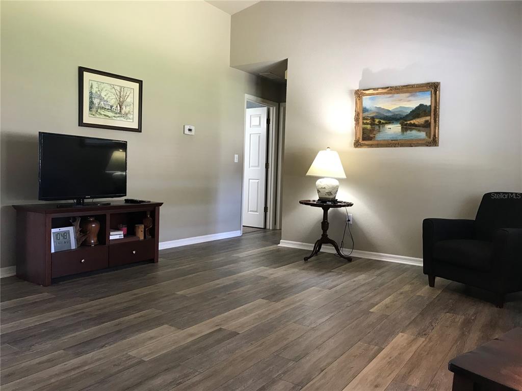 11879 Southwest 137th Loop Dunnellon, FL 34432 - Photo 10 of 37 a living room with furniture and a flat screen tv