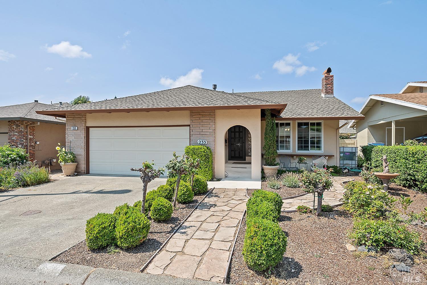 a front view of a house with garden