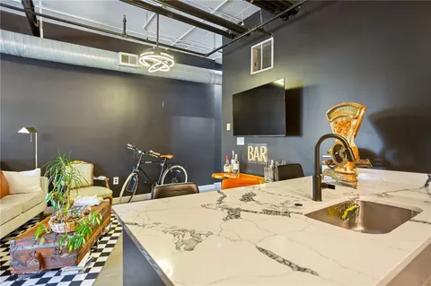 a bedroom with a bed and a large mirror on the dresser