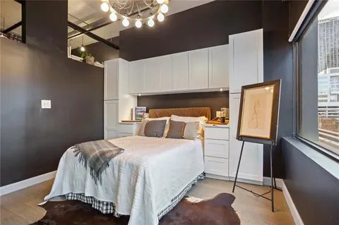 a bedroom with a bed and wooden floor