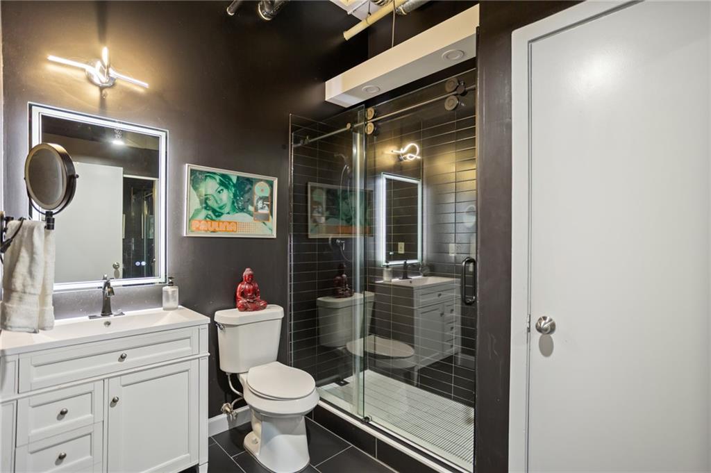 120 Ralph McGill Boulevard Northeast, Unit 405 Atlanta, GA 30308 - Photo 16 of 32 a bathroom with a toilet sink and shower