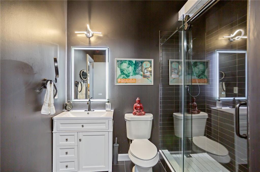 120 Ralph McGill Boulevard Northeast, Unit 405 Atlanta, GA 30308 - Photo 17 of 32 a bathroom with a toilet sink and mirror