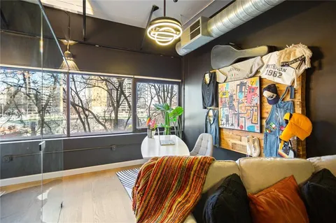 a bedroom with furniture and a large window