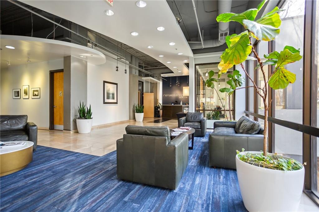 120 Ralph McGill Boulevard Northeast, Unit 405 Atlanta, GA 30308 - Photo 24 of 32 a living room with furniture and a potted plant