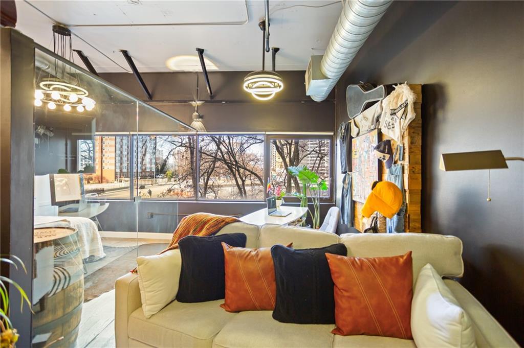 120 Ralph McGill Boulevard Northeast, Unit 405 Atlanta, GA 30308 - Photo 3 of 32 a view of a dining room with furniture a chandelier and a large window