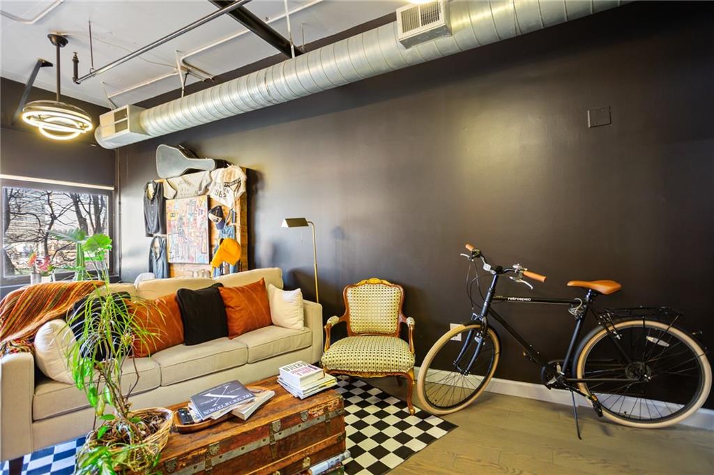 120 Ralph McGill Boulevard Northeast, Unit 405 Atlanta, GA 30308 - Photo 6 of 32 a living room with furniture a rug and a window