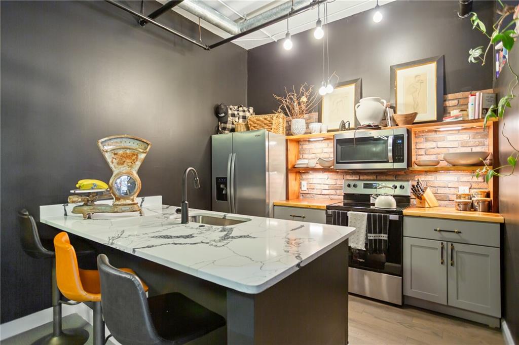 120 Ralph McGill Boulevard Northeast, Unit 405 Atlanta, GA 30308 - Photo 9 of 32 a kitchen with cabinets and appliances