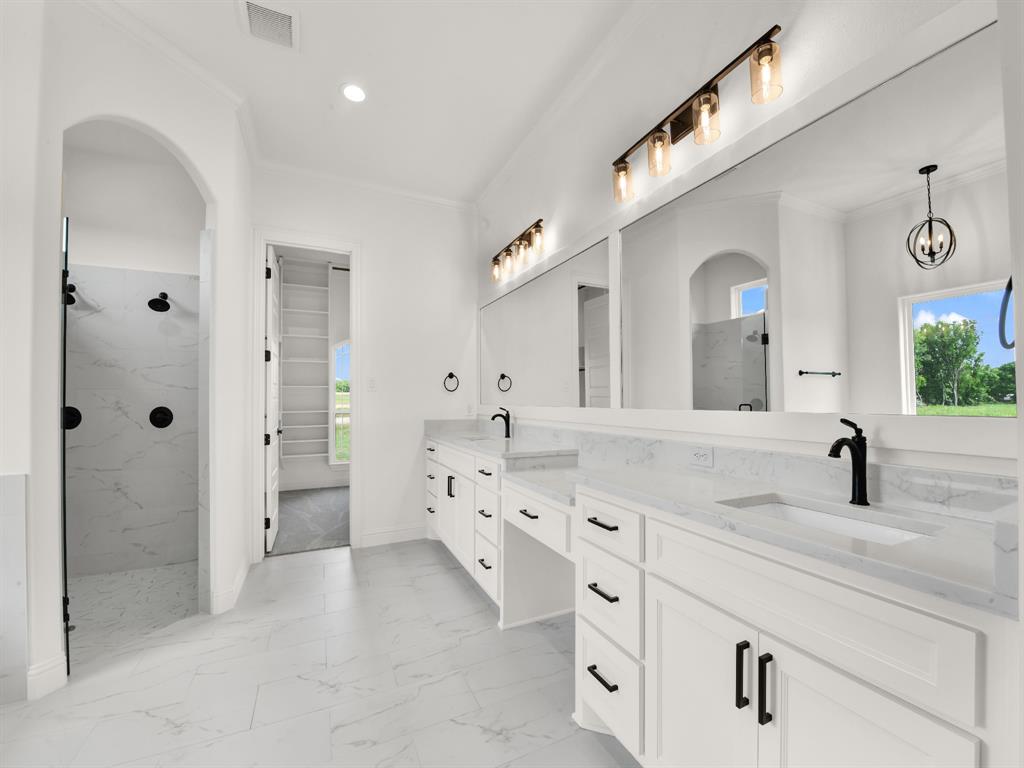 143 Desperado Way Weatherford, TX 76088 - Photo 26 of 36 Bathroom featuring crown molding, marble look tile flooring, a marble finish shower, double vanity, and recessed lighting