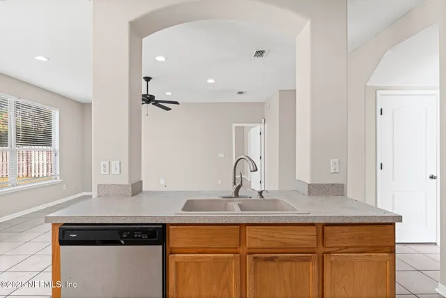a kitchen with granite countertop cabinets stainless steel appliances and a sink