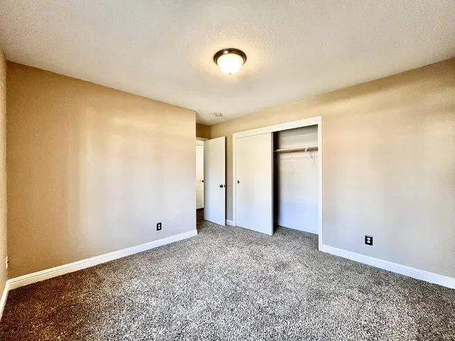 a view of a livingroom with a ceiling fan and window