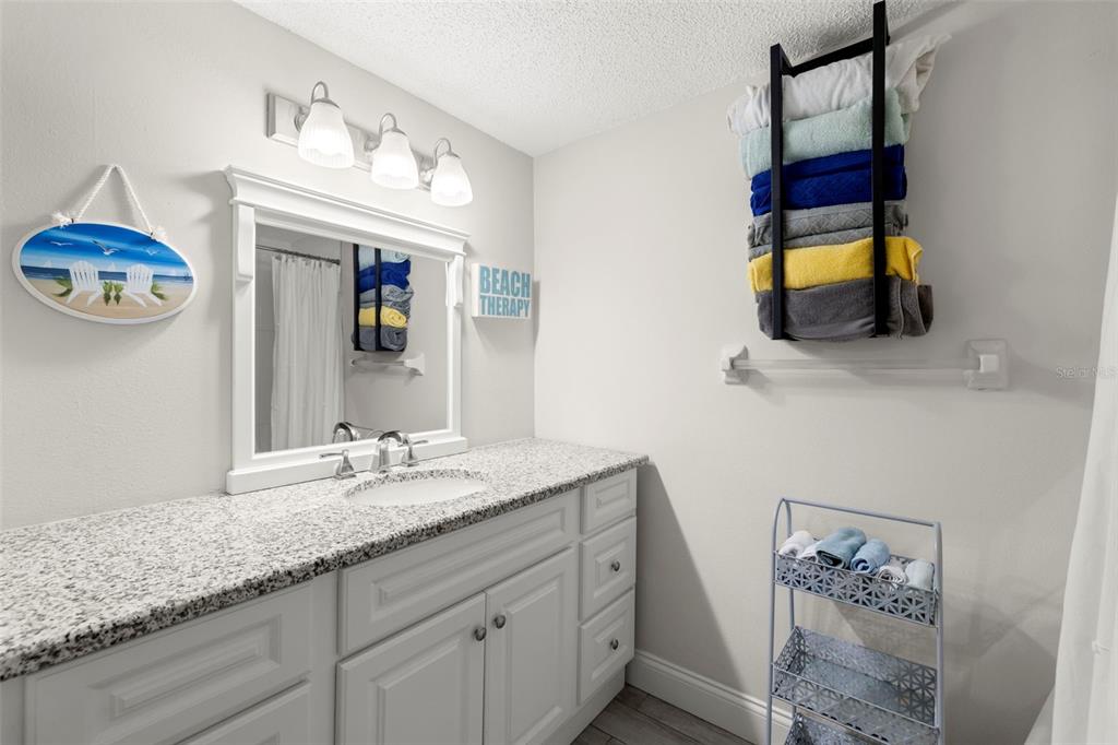 1370 Heather Ridge Boulevard, Unit 105 Dunedin, FL 34698 - Photo 19 of 56 a bathroom with a sink and a mirror