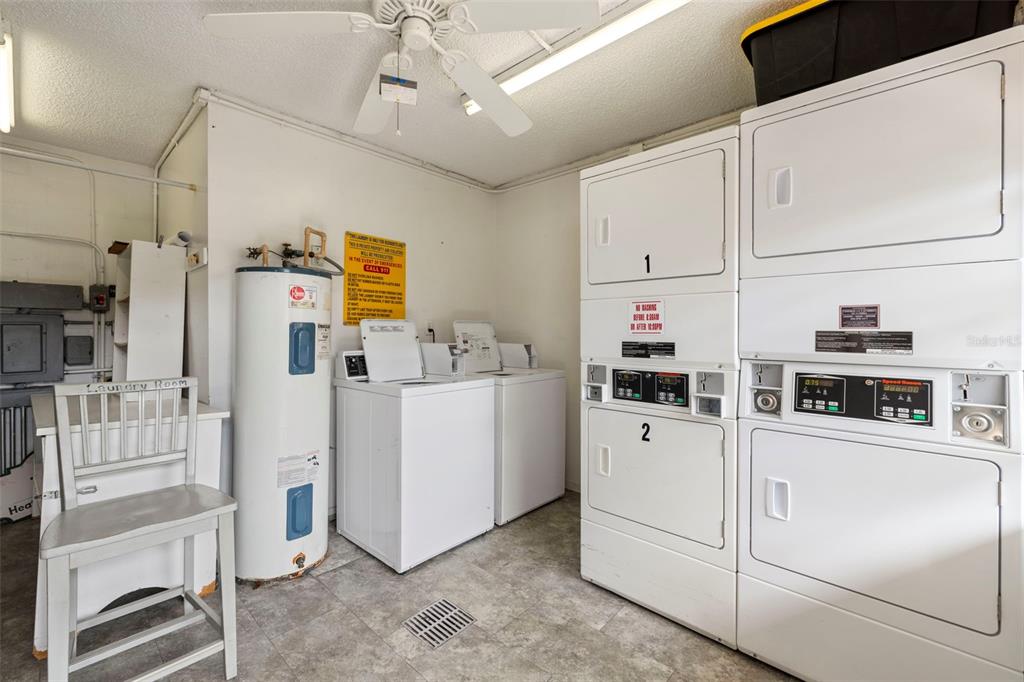 1370 Heather Ridge Boulevard, Unit 105 Dunedin, FL 34698 - Photo 36 of 56 a room with cabinets and white appliances