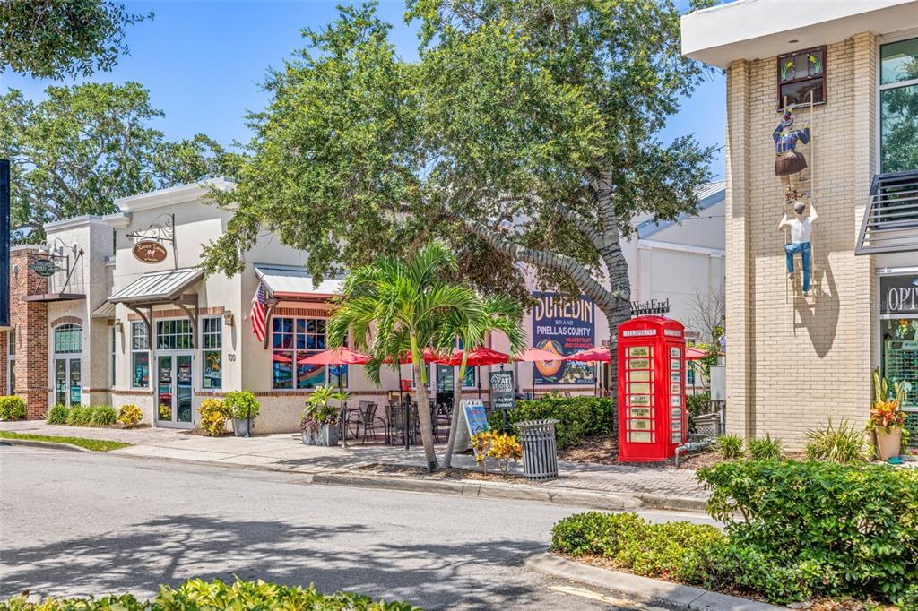 1370 Heather Ridge Boulevard, Unit 105 Dunedin, FL 34698 - Photo 42 of 56 a front view of multi story residential apartment building with yard and green space