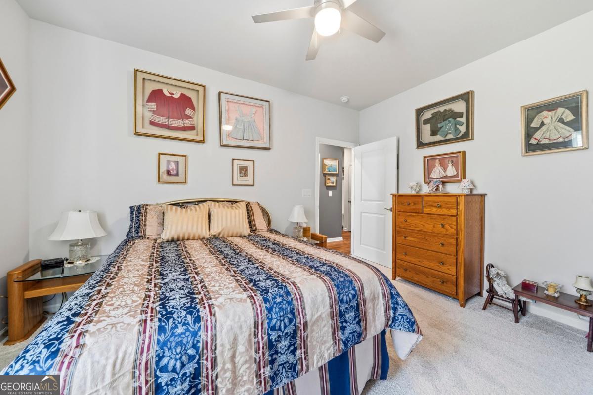1101 Little Shls Road Greensboro, GA 30642 - Photo 19 of 42 a bedroom with a bed and a chandelier